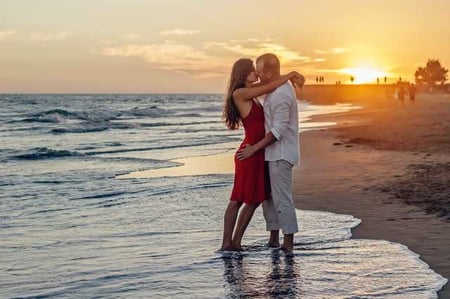 Man and woman embracing on a sunset beach