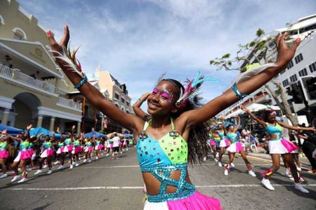 Young girl in colourful carnival-wear dancing in Bermuda Day street parade