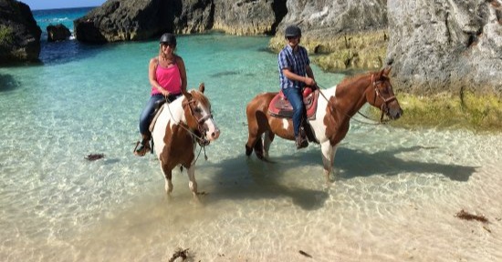 couples horse riding on the beach in bermuda 